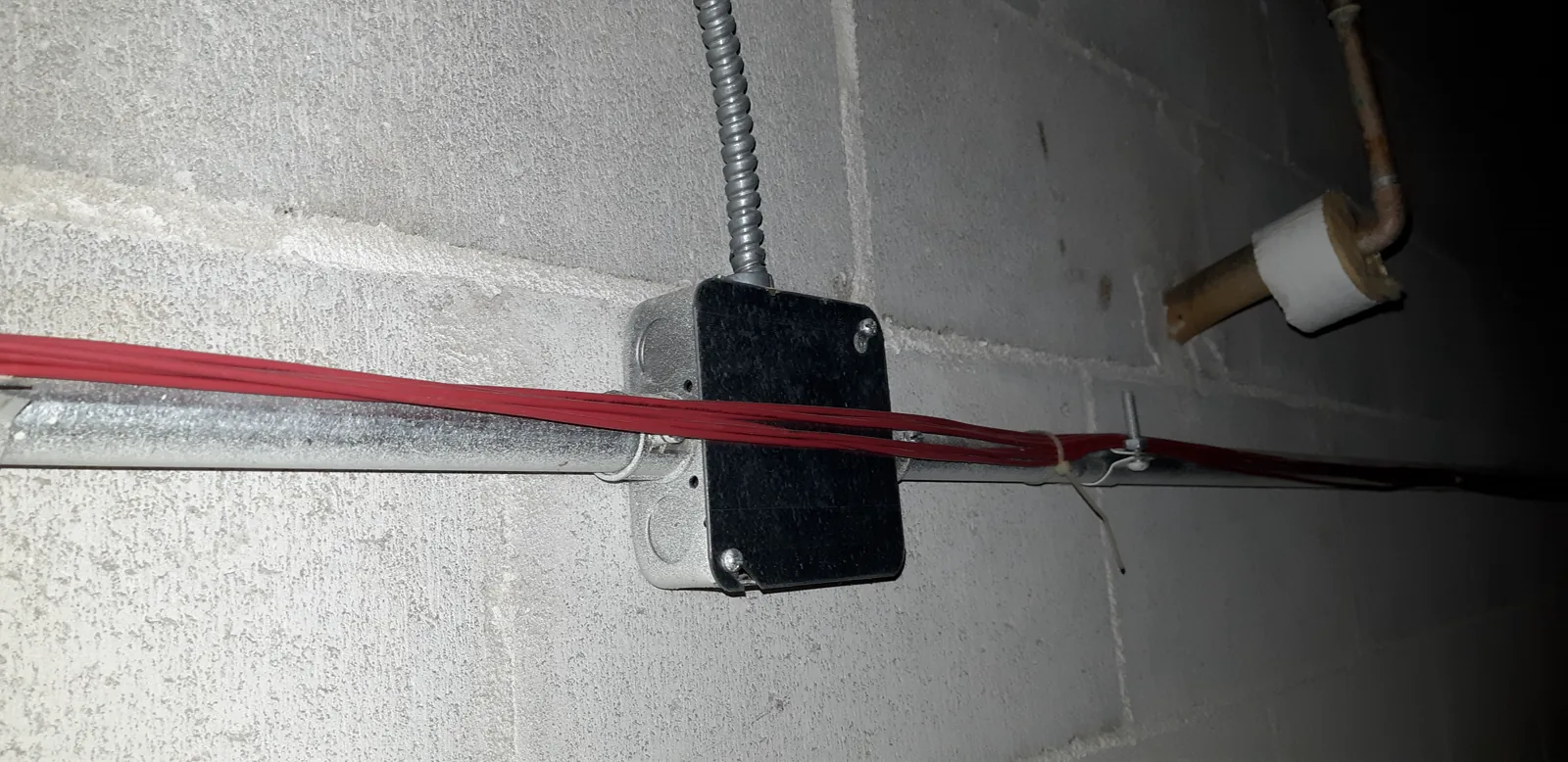 A crowded ceiling full of tangled cable
