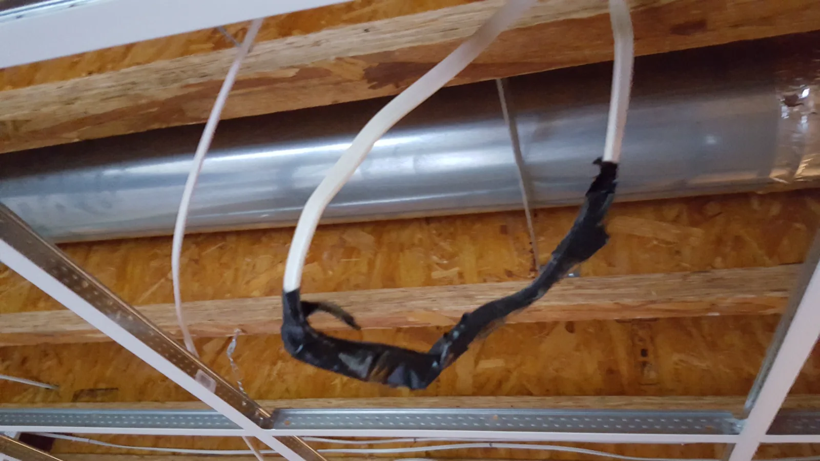 A flying 120-volt AC Romex splice wrapped in tape