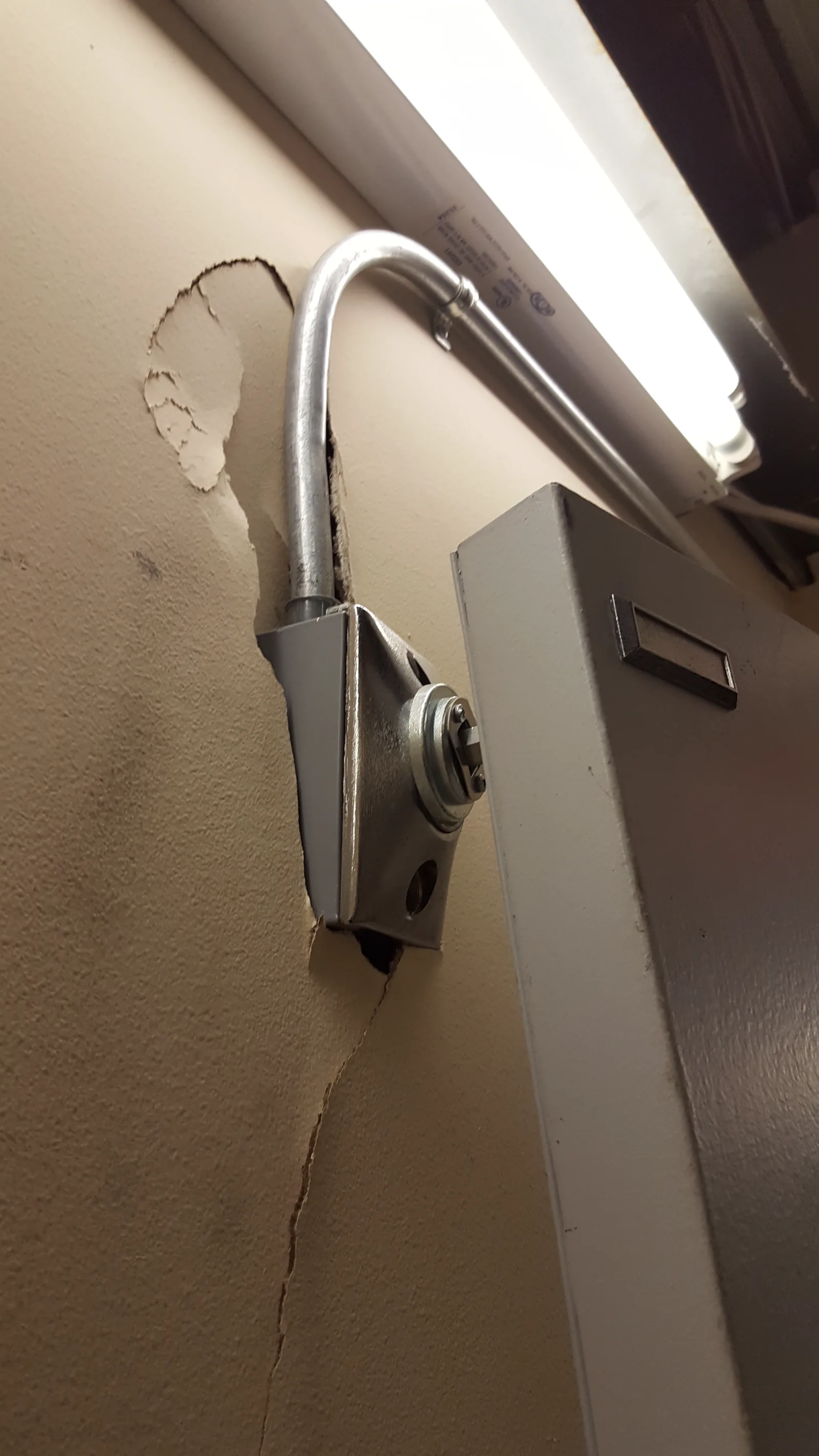 A poorly mounted device with visible cable