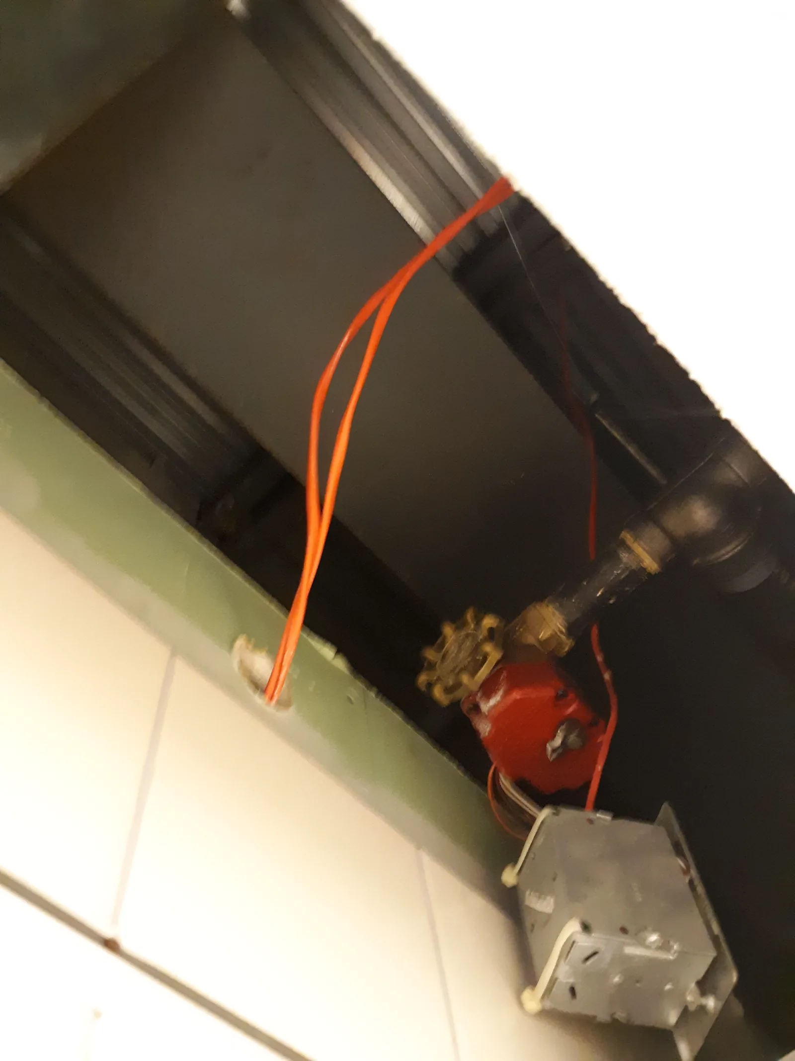 A junction box hanging from a sprinkler valve and feed wires