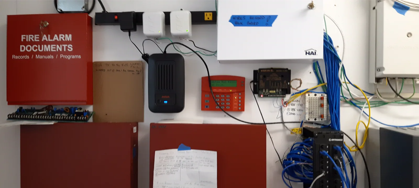 Phone boxes mounted beside a fire alarm maintenance keypad